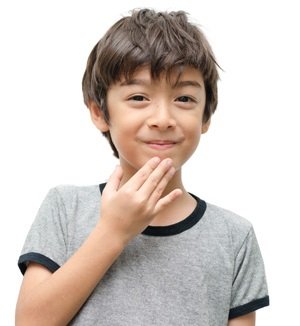 A boy giving the (ASL) American Sign Lanague hand sign for Thank You.